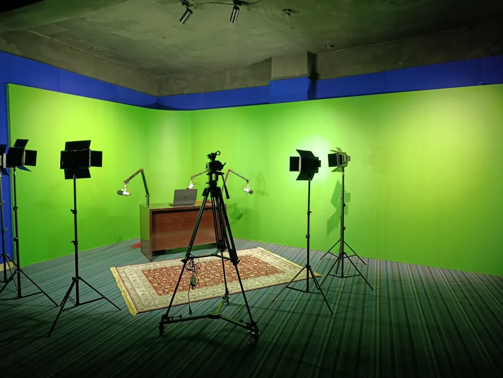 Chroma-key TV studio with blue acoustic walls and lighting, a Sound Krafted project